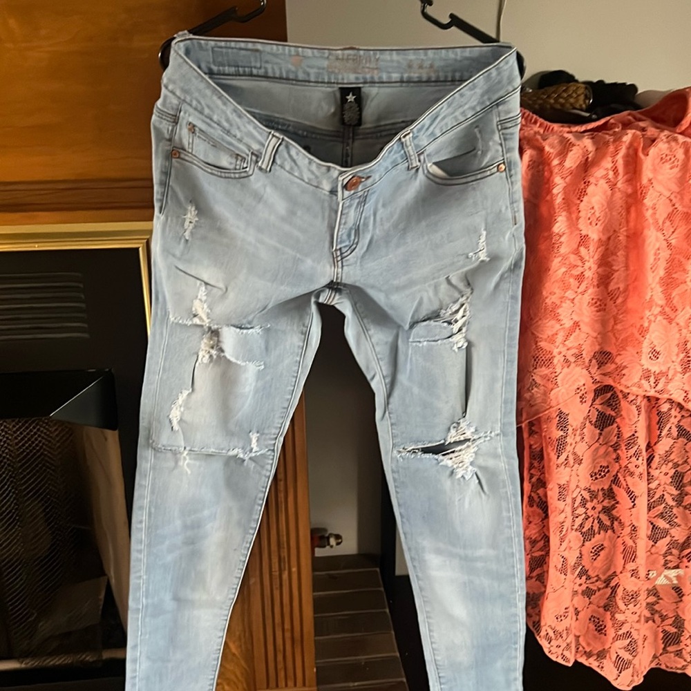 Ladies ripped celebrity pink, blue jeans.